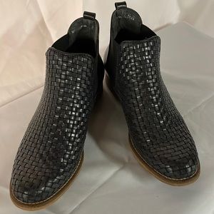 Black woven leather booties.